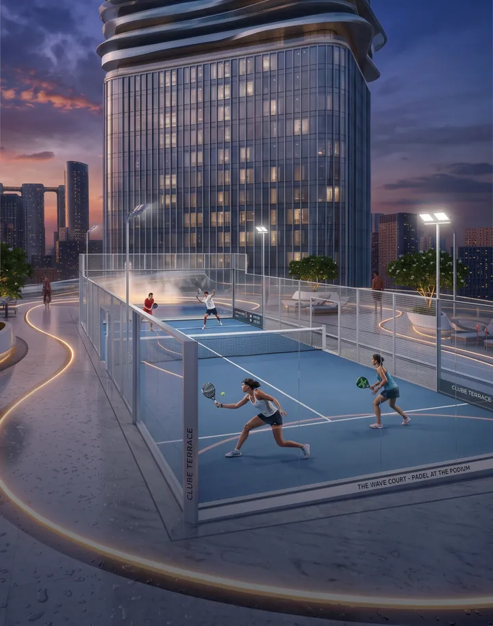 Two players on the outdoor padel court beneath the tower in the evening